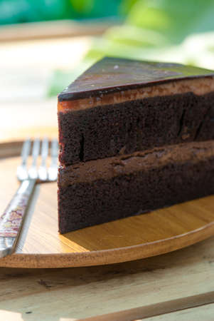 Delicious Chocolate cake on wooden plate