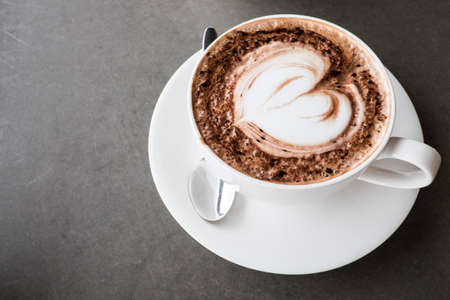 Heart shape Latte art on top of coffee cupの写真素材