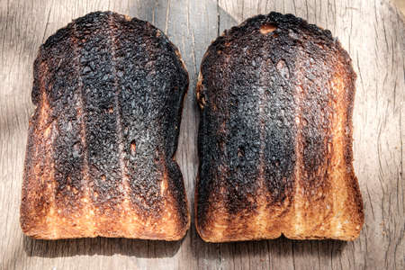 Crispy and Crunchy Over Burned Toasts place outdoor on wooden stool in Daylightの写真素材