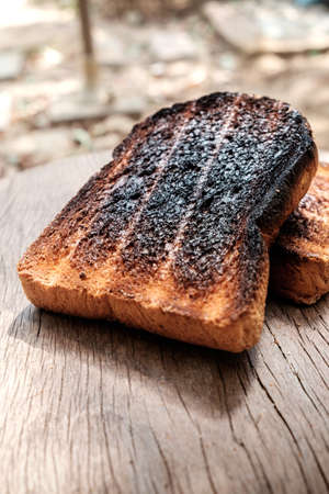 Crispy and Crunchy Over Burned Toasts place outdoor on wooden stool in Daylightの写真素材