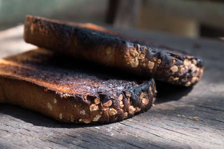 Crispy and Crunchy Over Burned Toasts place outdoor on wooden stool in Daylightの写真素材
