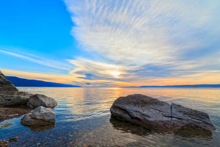 stones in water on sunriseの写真素材