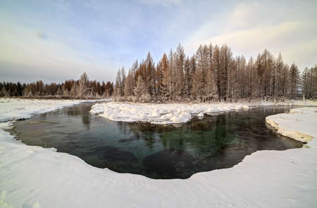 River bend in the background of the forest in the morning in the winterの写真素材