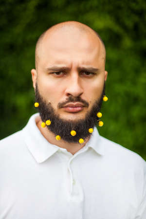 Portrait of funny man with decoration in his beard