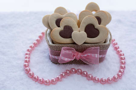 Pretty Rolled Chocolate Heart inside Vanilla Heart Sugar Cookies in a Ceramic bowl wraps with Burlapの写真素材