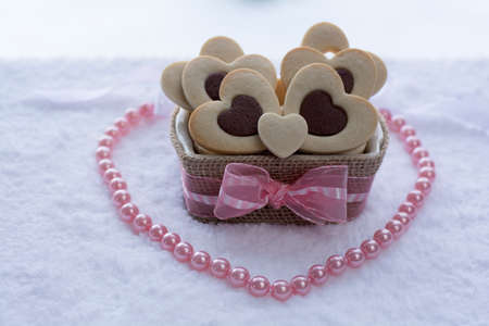 Pretty Rolled Chocolate Heart inside Vanilla Heart Sugar Cookies in a Ceramic bowl wraps with Burlap