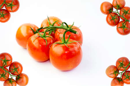 Red Fresh Ripe Stem Tomatoes and Four Corners Tomato Frame Isolated on White Fabric Backgroundの写真素材