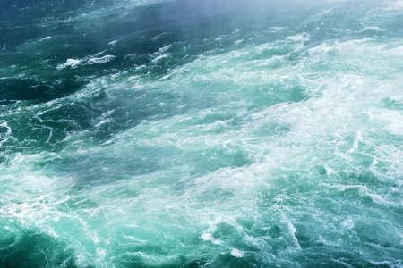 Green foamy water waveの写真素材