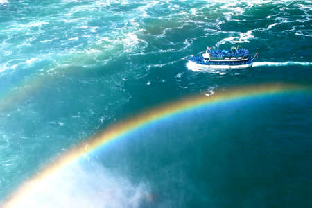 Boat floating above beautiful rainbow at Niagara Falls in Toronto Canadaの写真素材