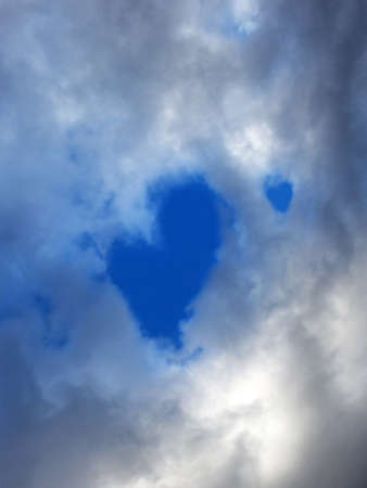 Storm cloud with heart shape blue skyの写真素材