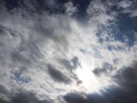 Dark gray cloud and lens flareの写真素材