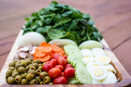 Fresh vegetable salad in wooden tray