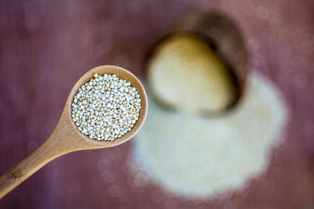 Dry quinoa in bamboo spoon with blurred quinoa background., Quinoa superfood photographyの写真素材