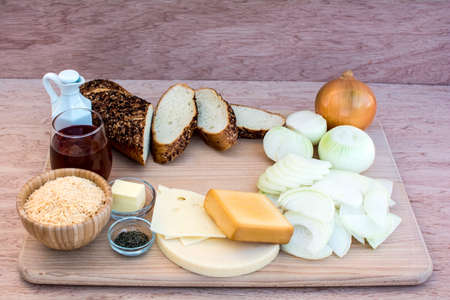 Easy french onion soup ingredients on wood cutting board and wood background, French onion soup ingredientsの写真素材