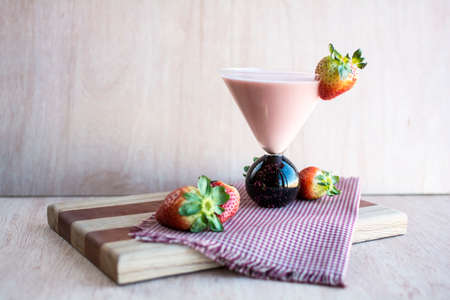 Fresh strawberry yogurt drink on red plaid napkin and cutting board, Healthy yogurt drink, Strawberry yogurt smoothyの写真素材