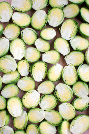 Fresh cut brussels sprout in half lay flat on wooden boardの写真素材