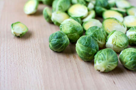 Fresh cut brussels sprout on wooden board with some spaces for words or texts, Selected focus brussels sprout on wooden cutting board, Blurred food backgroundの写真素材