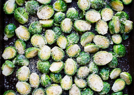 Fresh cut brussels sprout mixed with garlic parmesan cheese in baking sheet., Prepared fresh seasoning brussels sprout in baking sheet.の写真素材