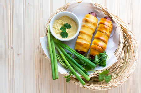 Pretzeldog in bamboo plate holder basket on wood backgroundの写真素材