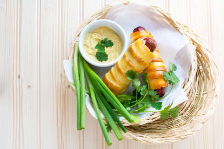 Pretzeldog in bamboo plate holder basket on wood backgroundの写真素材