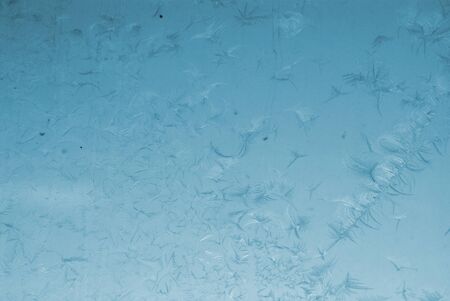blue winter frosted window with beautiful tracery