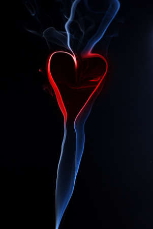 Blue smoke texture at black background with red heartの写真素材