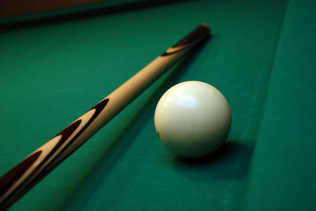 picture of green billiard table with white ball and cue