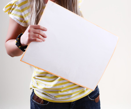 Woman takes placard at white backgroundの写真素材