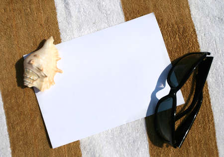 Seashell and sunglasses on paper background frame