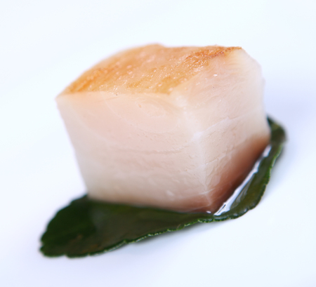 Fresh white fish decorated with greens close-up