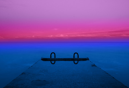 concrete pier on the sea and blue sky with cloudsの写真素材