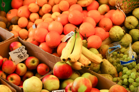 Bright colorful ripe fruits laid out in the market stallsの写真素材