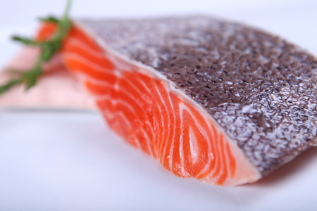 Raw fresh red salmon at white plateの写真素材