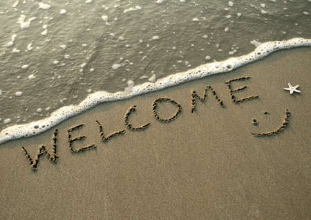 word vacation is writ on the sand of the beachの写真素材