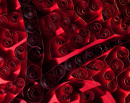 Quilling. Beautiful red hearts made ??of twisted paper.