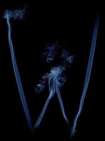 grey letter W from smoke on black backgroundの写真素材