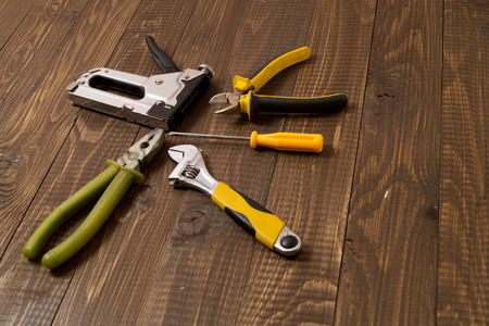 Necessary locksmith's tools for work are on the wooden table