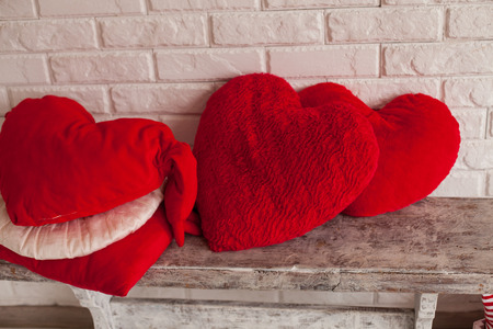 Cute heart-shaped pillows on the wood benchの写真素材