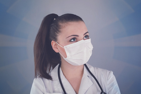 Nurse with ponytail and with gauze is against grey background