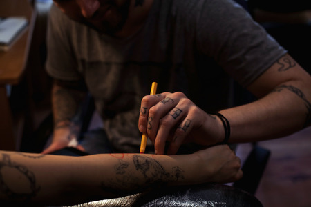 The tattoo artist is preparing the area that will be tattooedの写真素材