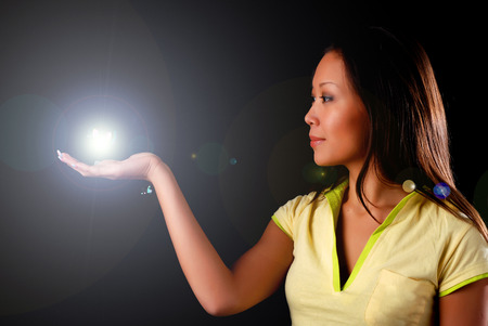 beautiful young woman witn sphere at black backgroundの写真素材