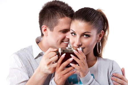 Young couple of man and woman drinking teaの写真素材
