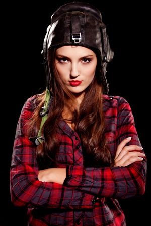 young woman in red cell shirt with black helmet on her headの写真素材