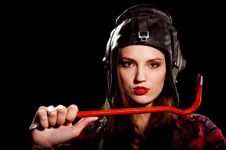 young beautiful woman in cell shirt with red crowbarの写真素材
