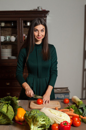 A tomato is cuted by a womanの写真素材