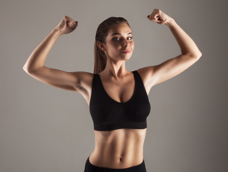 Young slim model doing strength training in studioの写真素材