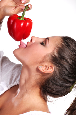 beautiful woman in white dress with fresh paprikaの写真素材