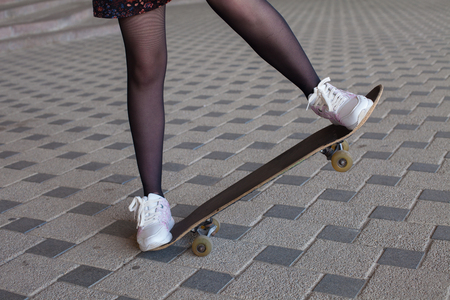 Girl's legs riding on the skateboardの写真素材