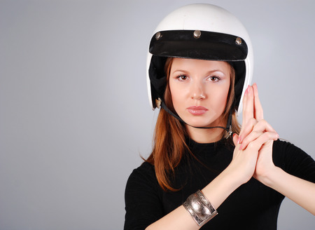 young beautiful woman in black clothes and white helmetの写真素材