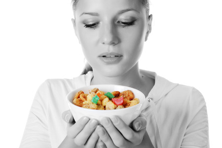 portrait of young woman with plate of muesliの写真素材